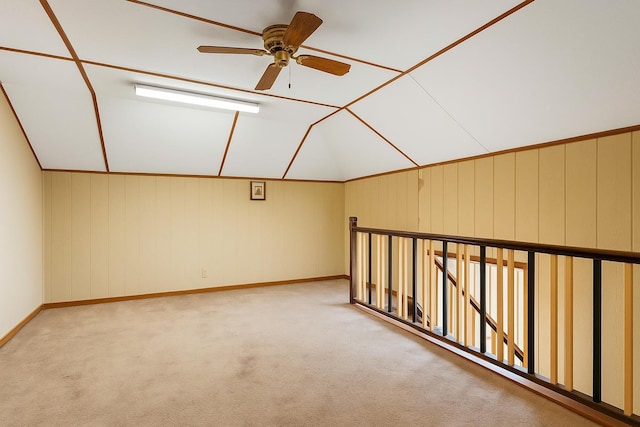 bonus room featuring a ceiling fan, carpet, baseboards, and lofted ceiling