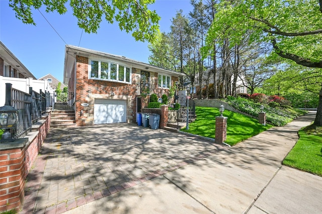 view of front of property featuring stairs, decorative driveway, a garage, and brick siding