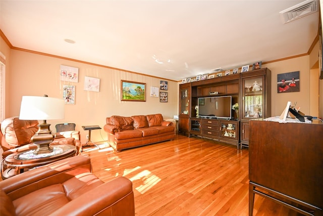 living room with crown molding and light wood-type flooring