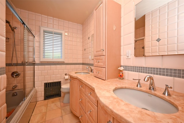 full bathroom with tile walls, toilet, tile patterned floors, enclosed tub / shower combo, and radiator