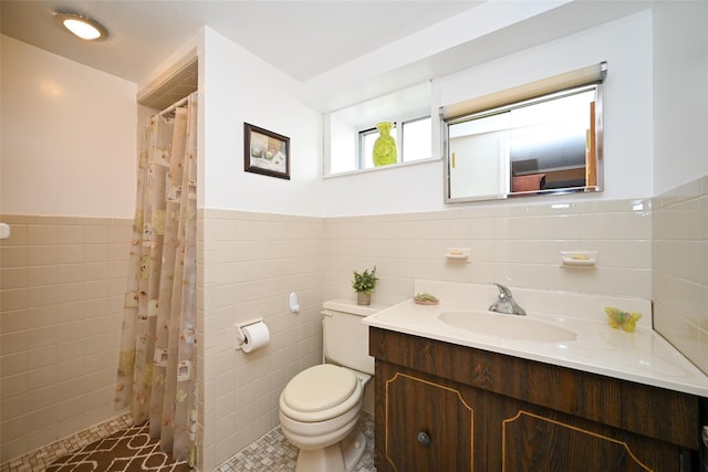 full bathroom with tile walls, toilet, wainscoting, vanity, and curtained shower