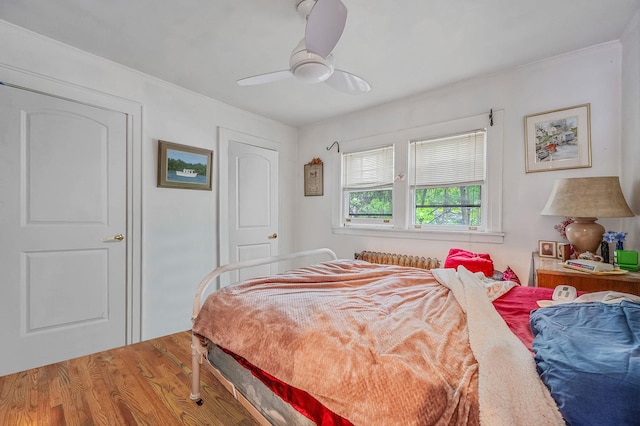 bedroom featuring wood finished floors and a ceiling fan