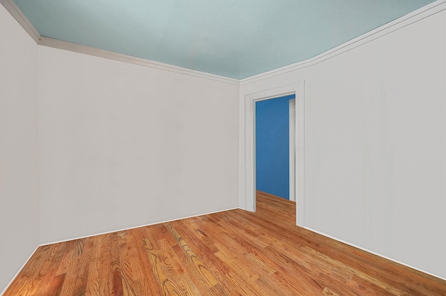 unfurnished room featuring light wood finished floors and ornamental molding
