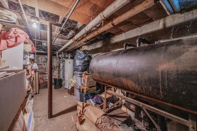 unfinished basement featuring gas water heater and oil tank