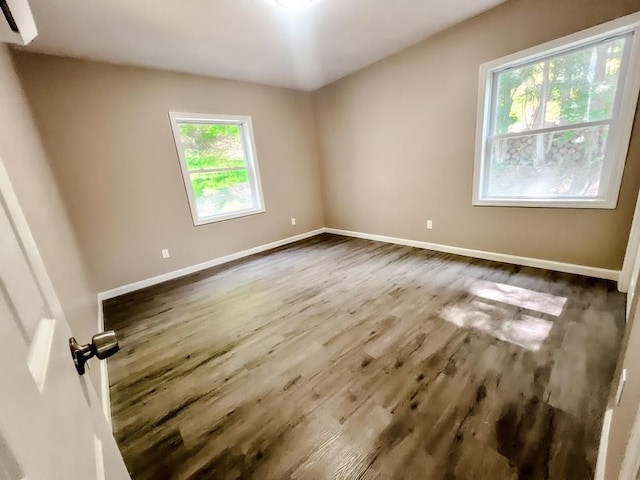 936 State Route 55a, Neversink, NY 12458 - spare room with dark wood finished floors, baseboards, and a wall unit AC