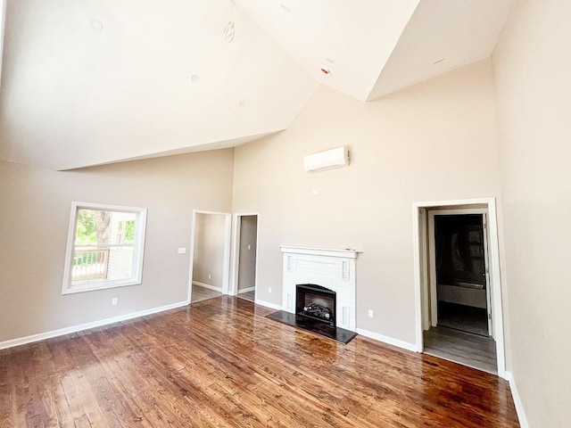 936 State Route 55a, Neversink, NY 12458 - unfurnished living room featuring high vaulted ceiling, wood finished floors, baseboards, and a fireplace with raised hearth
