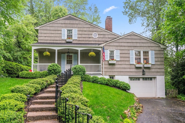 view of front of house featuring an attached garage, a chimney, driveway, covered porch, and stairway