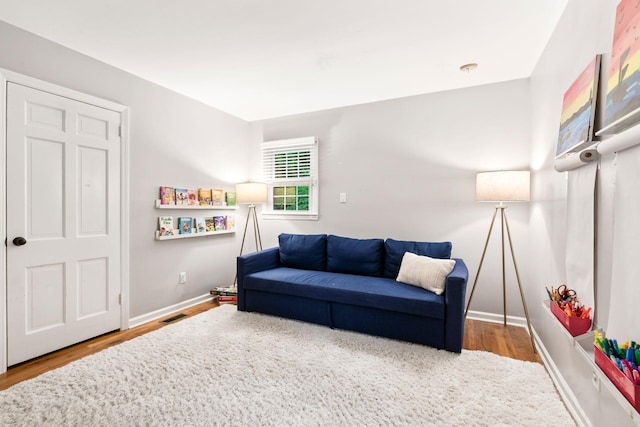 living area featuring wood finished floors and baseboards