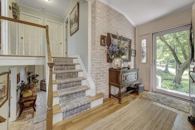 10 Falcon Pl, Huntington, NY 11743 - entrance foyer featuring ornamental molding, wood finished floors, vaulted ceiling, and stairway