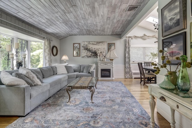 10 Falcon Pl, Huntington, NY 11743 - living area featuring lofted ceiling, a fireplace, wood finished floors, and wood ceiling