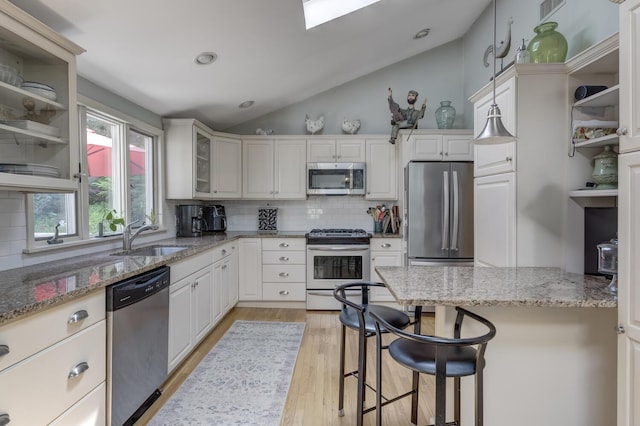 10 Falcon Pl, Huntington, NY 11743 - kitchen with stainless steel appliances, a sink, backsplash, light wood-style floors, and glass insert cabinets