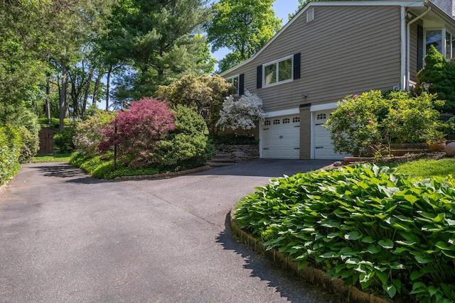 10 Falcon Pl, Huntington, NY 11743 - view of side of home with driveway and a garage