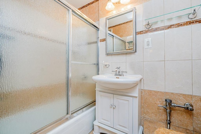 2265 Gerritsen Ave Unit 5C, Brooklyn, NY 11229 - full bathroom featuring decorative backsplash, tile walls, bath / shower combo with glass door, and vanity