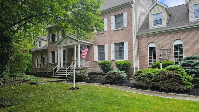17 Stonegate Dr, Hyde Park, NY 12538 - view of front of property with brick siding, a front lawn, and roof with shingles