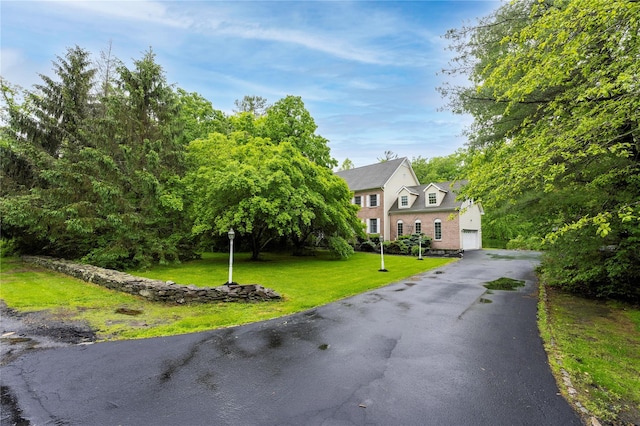 17 Stonegate Dr, Hyde Park, NY 12538 - view of front facade with asphalt driveway and a front yard