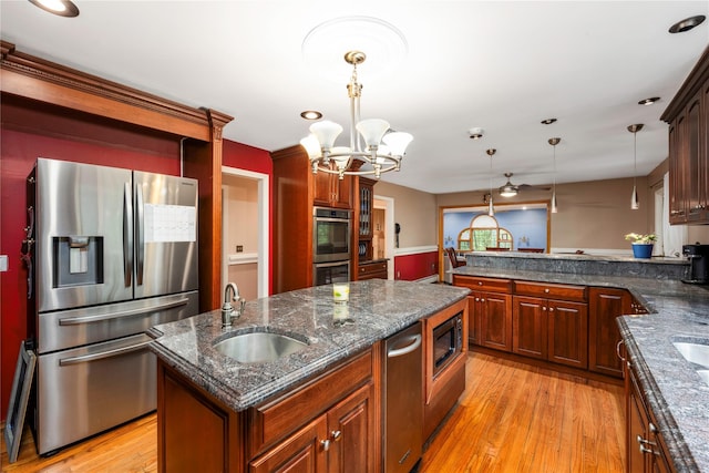 17 Stonegate Dr, Hyde Park, NY 12538 - kitchen with stainless steel appliances, a chandelier, hanging light fixtures, light wood-style flooring, and a peninsula