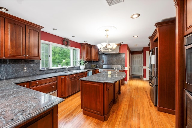 17 Stonegate Dr, Hyde Park, NY 12538 - kitchen with a sink, freestanding refrigerator, a chandelier, range, and decorative backsplash
