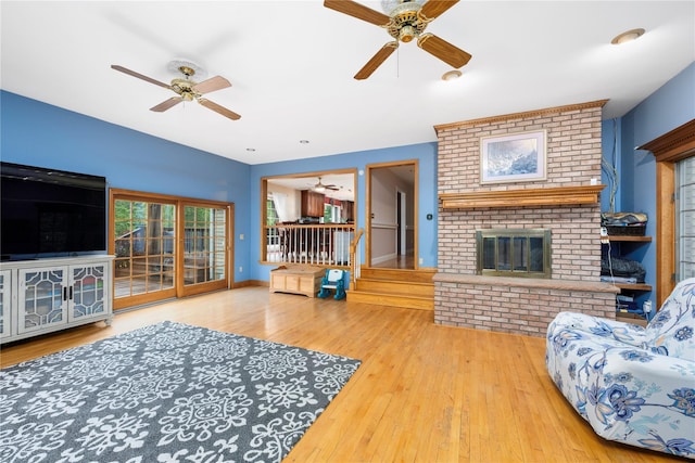 17 Stonegate Dr, Hyde Park, NY 12538 - living area with ceiling fan, a brick fireplace, wood-type flooring, and baseboards