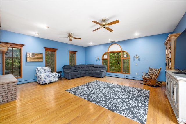 17 Stonegate Dr, Hyde Park, NY 12538 - living room with a baseboard heating unit, wood-type flooring, and a ceiling fan