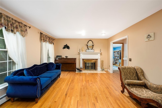 17 Stonegate Dr, Hyde Park, NY 12538 - living area featuring light wood finished floors, baseboard heating, and a fireplace