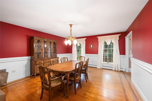 17 Stonegate Dr, Hyde Park, NY 12538 - dining space with a chandelier, wainscoting, light wood finished floors, and a baseboard radiator