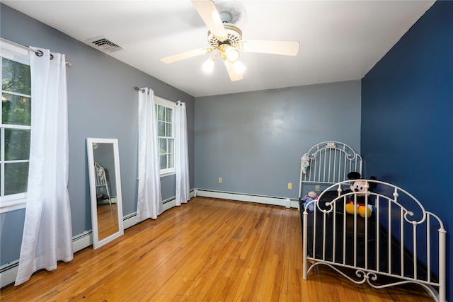 17 Stonegate Dr, Hyde Park, NY 12538 - interior space with baseboard heating, healthy amount of natural light, wood-type flooring, and a ceiling fan