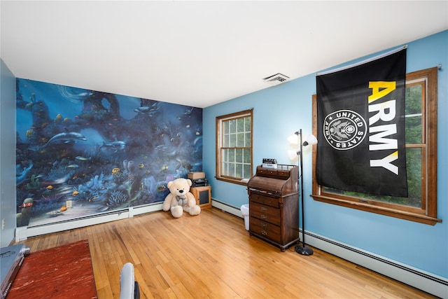 17 Stonegate Dr, Hyde Park, NY 12538 - interior space featuring an accent wall, baseboard heating, wallpapered walls, wood-type flooring, and baseboards