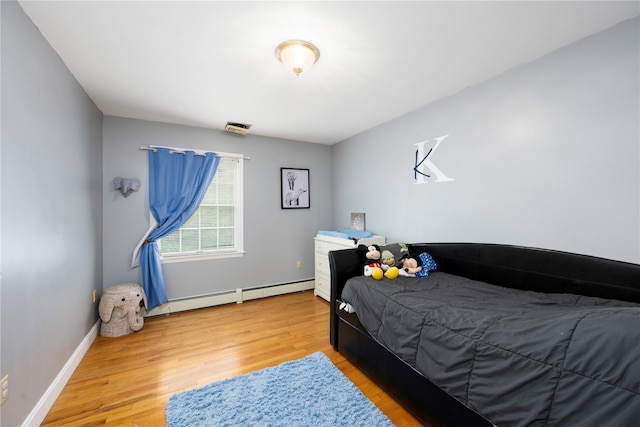 17 Stonegate Dr, Hyde Park, NY 12538 - bedroom with a baseboard radiator, light wood finished floors, and baseboards
