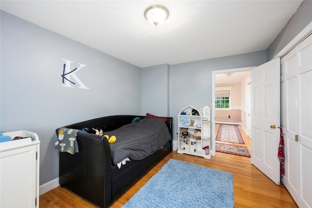 17 Stonegate Dr, Hyde Park, NY 12538 - bedroom featuring baseboard heating, light wood-type flooring, and baseboards