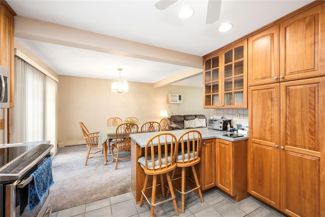 3 Sodano Rd, Hopewell Junction, NY 12533 - kitchen with a peninsula, stainless steel electric range oven, brown cabinets, light carpet, and glass insert cabinets