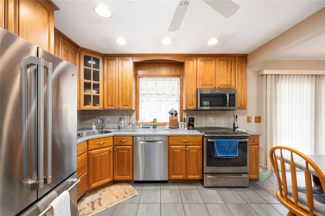 3 Sodano Rd, Hopewell Junction, NY 12533 - kitchen featuring stainless steel appliances, a sink, brown cabinetry, backsplash, and ceiling fan