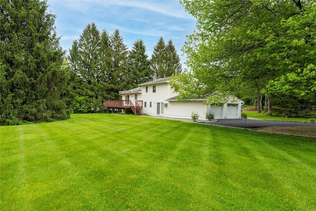 3 Sodano Rd, Hopewell Junction, NY 12533 - view of green lawn with asphalt driveway, a wooden deck, and an attached garage