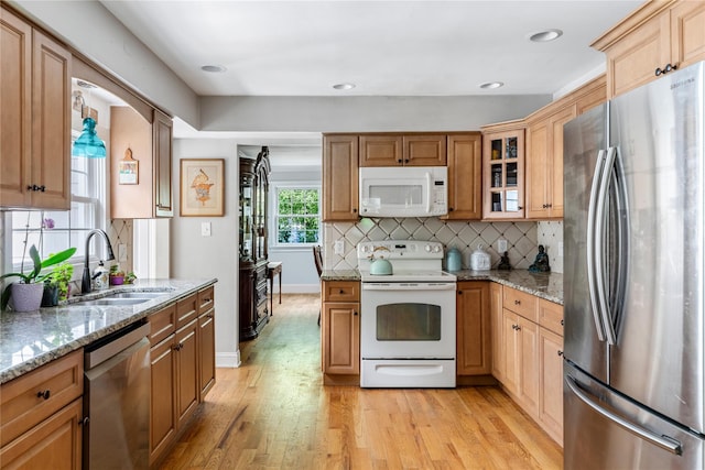 85 Shore Rd, Amityville, NY 11701 - kitchen featuring stainless steel appliances, a sink, light wood-style flooring, decorative backsplash, and light stone countertops