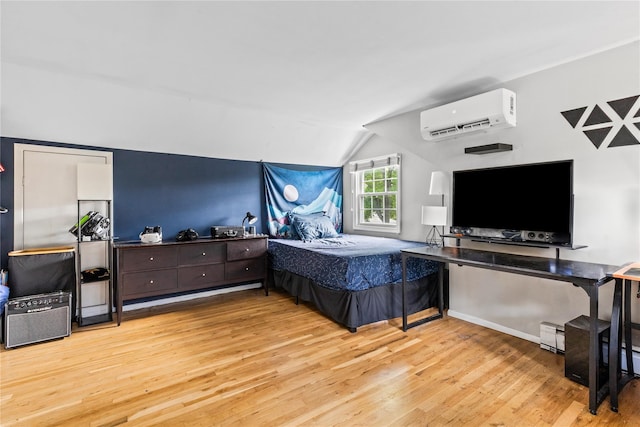 85 Shore Rd, Amityville, NY 11701 - bedroom with a wall mounted AC, vaulted ceiling, light wood-type flooring, and a baseboard radiator