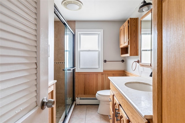 85 Shore Rd, Amityville, NY 11701 - bathroom with a baseboard heating unit, tile patterned floors, toilet, vanity, and a stall shower