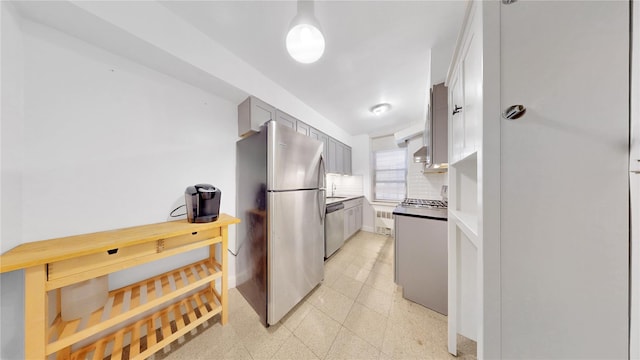 kitchen with stainless steel appliances, baseboards, light countertops, and backsplash