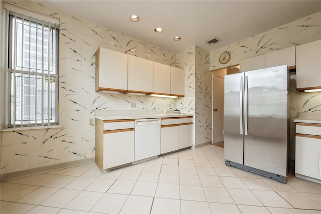 1175 E Broadway Unit 2J, Hewlett, NY 11557 - kitchen with white dishwasher, freestanding refrigerator, light countertops, recessed lighting, and wallpapered walls
