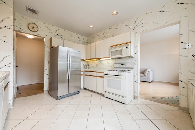 1175 E Broadway Unit 2J, Hewlett, NY 11557 - kitchen featuring white appliances, recessed lighting, and light countertops