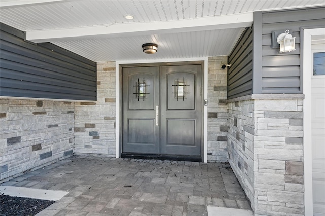 8 Clinton Ct, Monroe, NY 10950 - view of exterior entry with stone siding and a porch