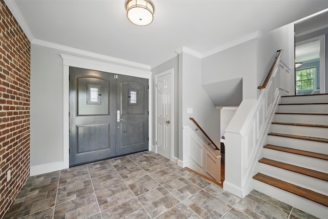 8 Clinton Ct, Monroe, NY 10950 - entrance foyer featuring stone finish flooring, brick wall, baseboards, ornamental molding, and stairway