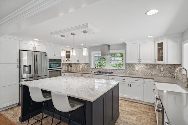 8 Clinton Ct, Monroe, NY 10950 - kitchen with a sink, stainless steel appliances, a kitchen island, white cabinetry, and light wood-style floors