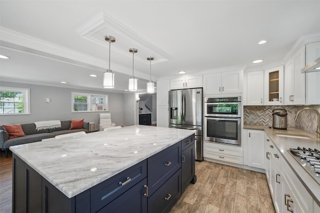 8 Clinton Ct, Monroe, NY 10950 - kitchen featuring stainless steel appliances, a sink, ornamental molding, white cabinets, and light wood-type flooring