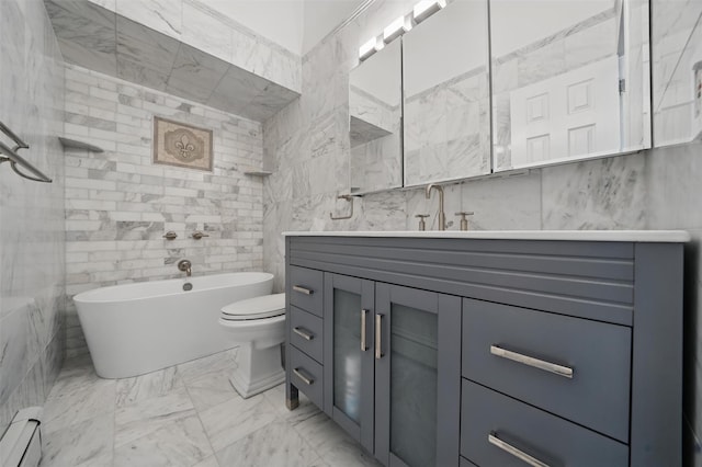 8 Clinton Ct, Monroe, NY 10950 - bathroom with tile walls, baseboard heating, a soaking tub, vanity, and marble finish floors