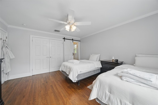 8 Clinton Ct, Monroe, NY 10950 - bedroom featuring a closet, crown molding, wood finished floors, a barn door, and baseboards