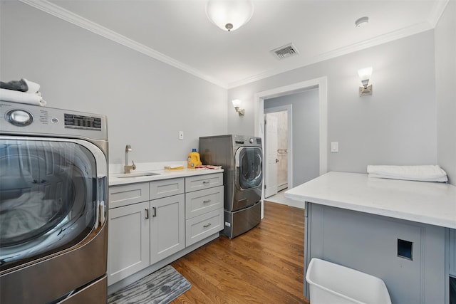 8 Clinton Ct, Monroe, NY 10950 - washroom featuring cabinet space, ornamental molding, dark wood-type flooring, and independent washer and dryer