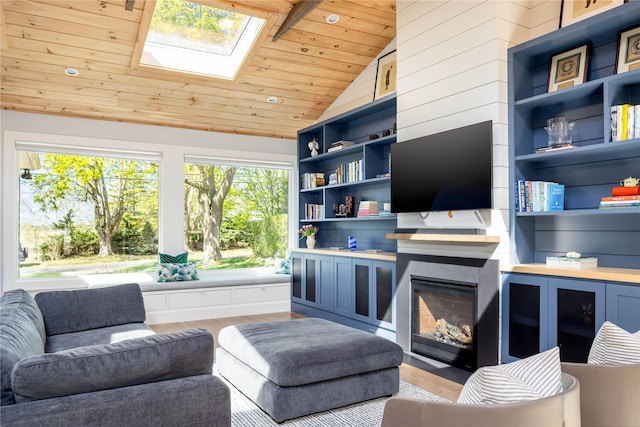 2865 S Harbor Rd, Southold, NY 11971 - living area with wooden ceiling, vaulted ceiling, healthy amount of natural light, a skylight, and a glass covered fireplace