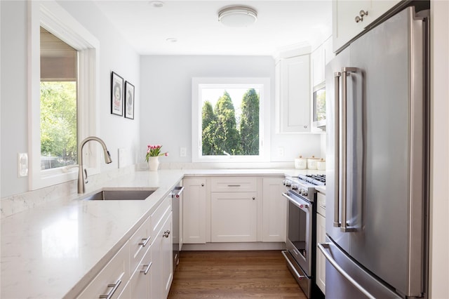 2865 S Harbor Rd, Southold, NY 11971 - kitchen with premium appliances, a sink, light stone countertops, white cabinetry, and wood finished floors