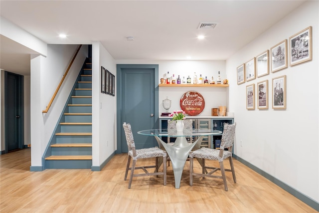2865 S Harbor Rd, Southold, NY 11971 - dining area with stairway, a dry bar, wood finished floors, and recessed lighting