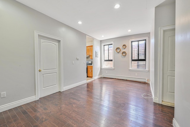 5130 35th St, Long Island City, NY 11101 - unfurnished living room with a baseboard heating unit, dark wood finished floors, baseboards, and recessed lighting