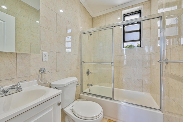 5130 35th St, Long Island City, NY 11101 - bathroom featuring tile walls, shower / bath combination with glass door, vanity, toilet, and ornamental molding